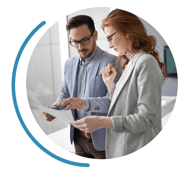 Image of two people discussing a business contract.