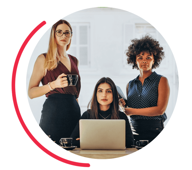 Image of three women at a desk. 