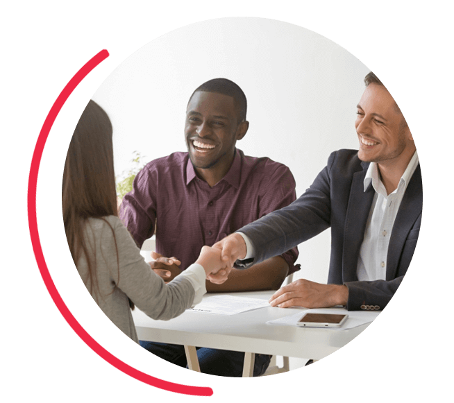 Image of business people shaking hands over a contract. 
