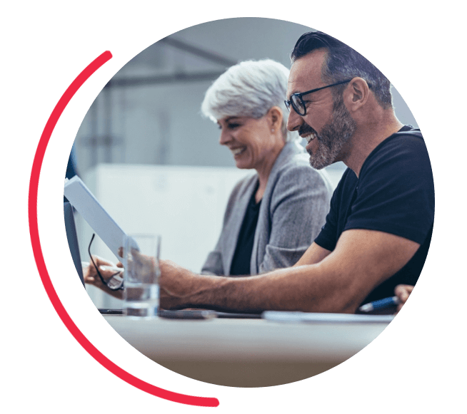 Image of three business people looking over a business contract. 