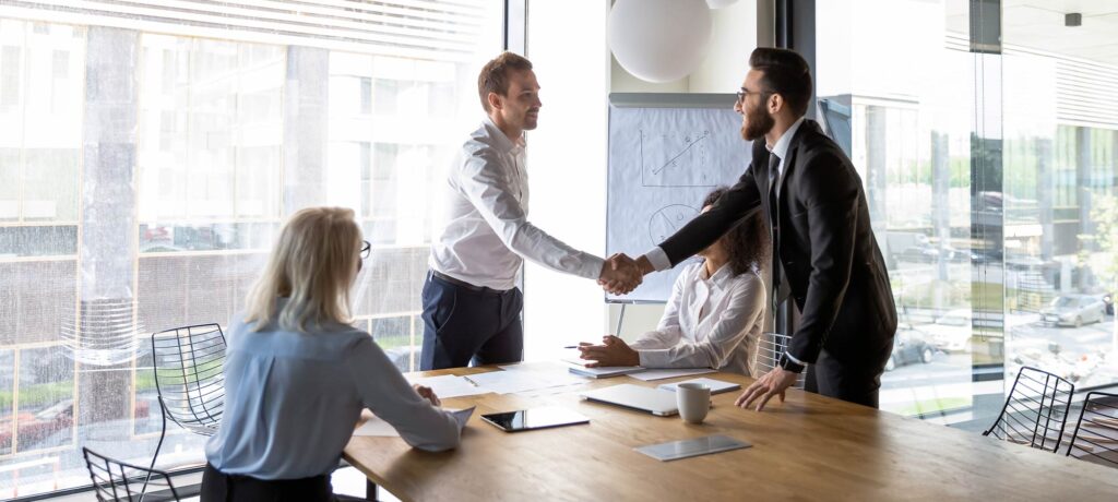 people shaking hands in a meeting