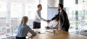 people shaking hands in a meeting