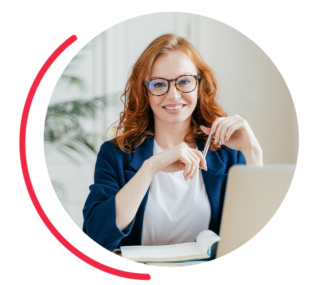 a business woman smiling with her laptop and notepad
