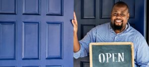 a man holding an open sign