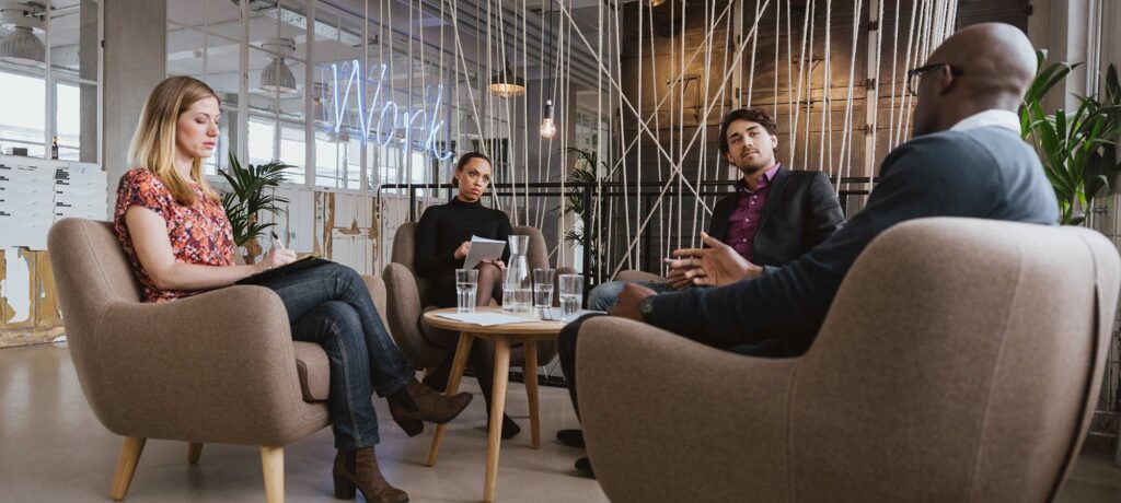 business people at a table, chatting