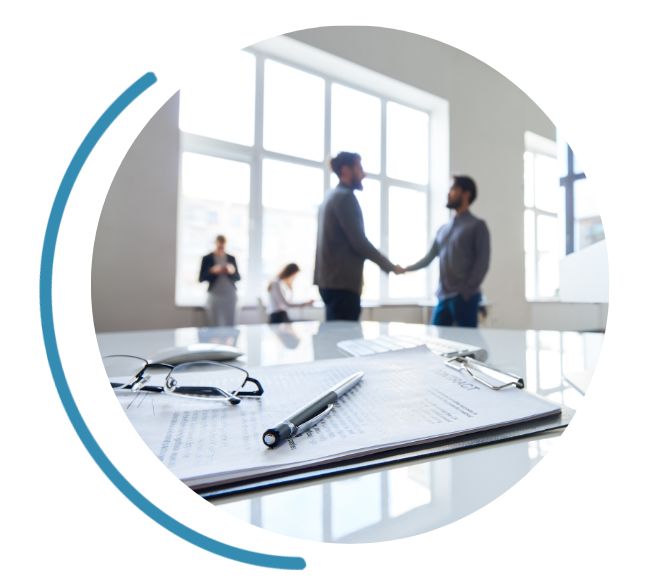 people shaking hands with paperwork