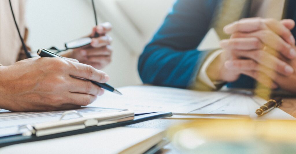 Closeup of two professionals going over documents