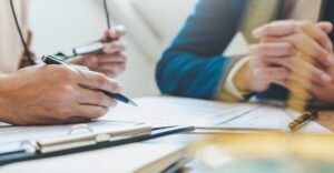 Closeup of two professionals going over documents