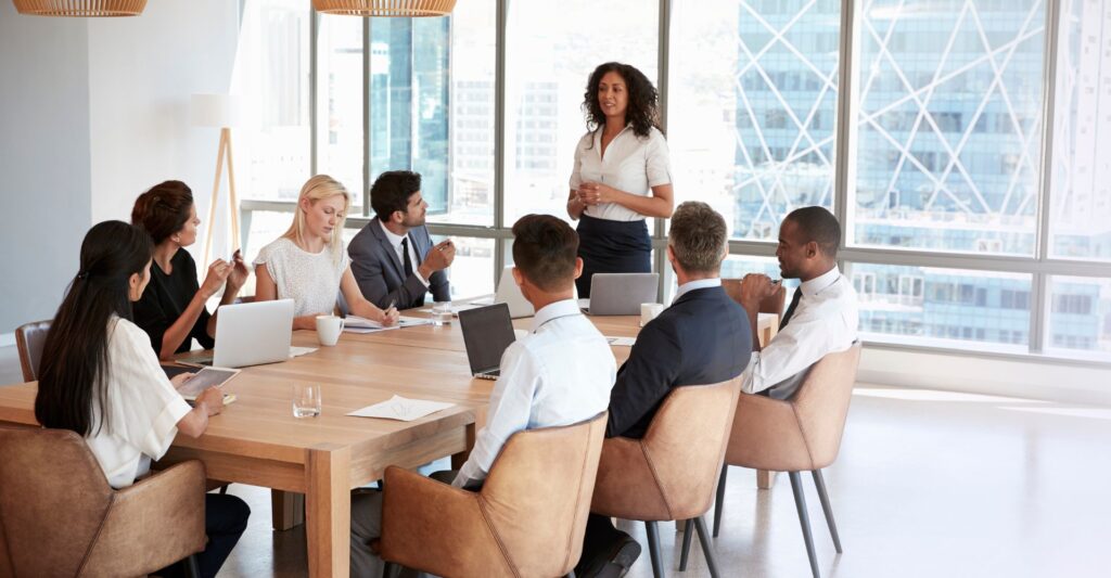 Employees gathered at a table for a team meeting