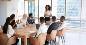 Employees gathered at a table for a team meeting