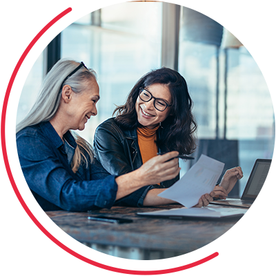 Two women smiling during a meeting
