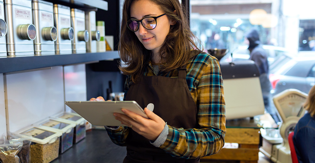 A business owner doing inventory with a tablet