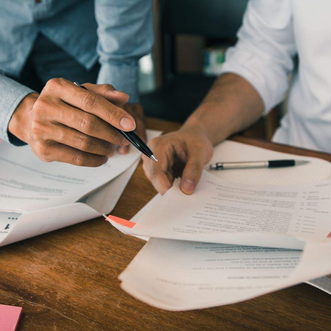 two people looking over paperwork