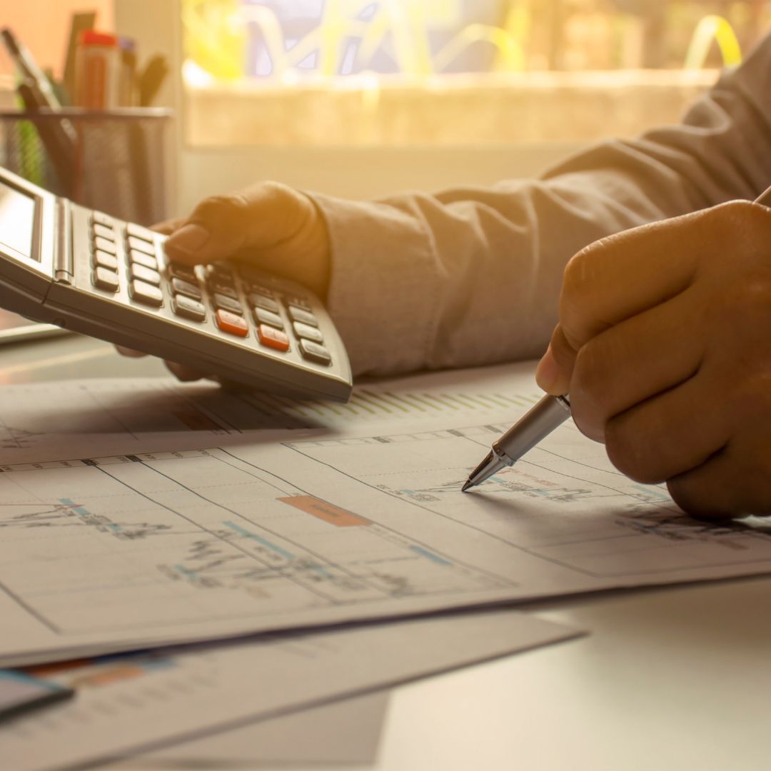 businessman calculating numbers on calculator