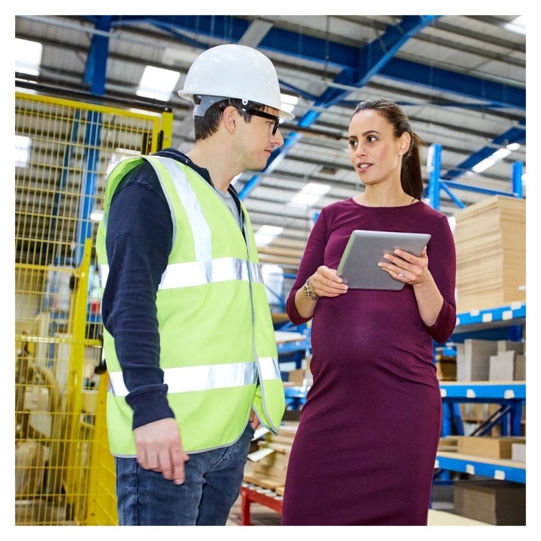 Pregnant employee talking to coworker