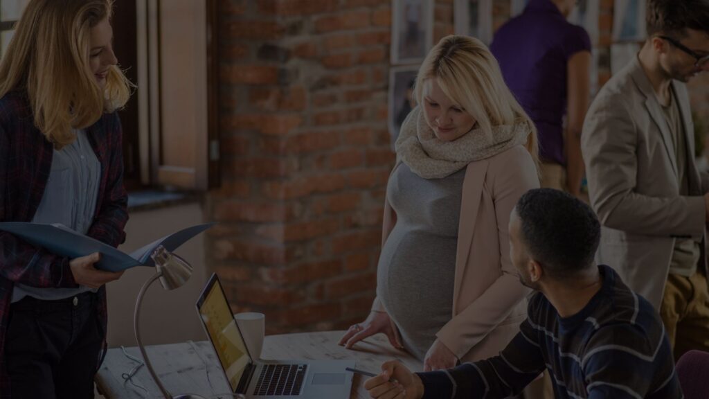 Pregnant employee with coworkers