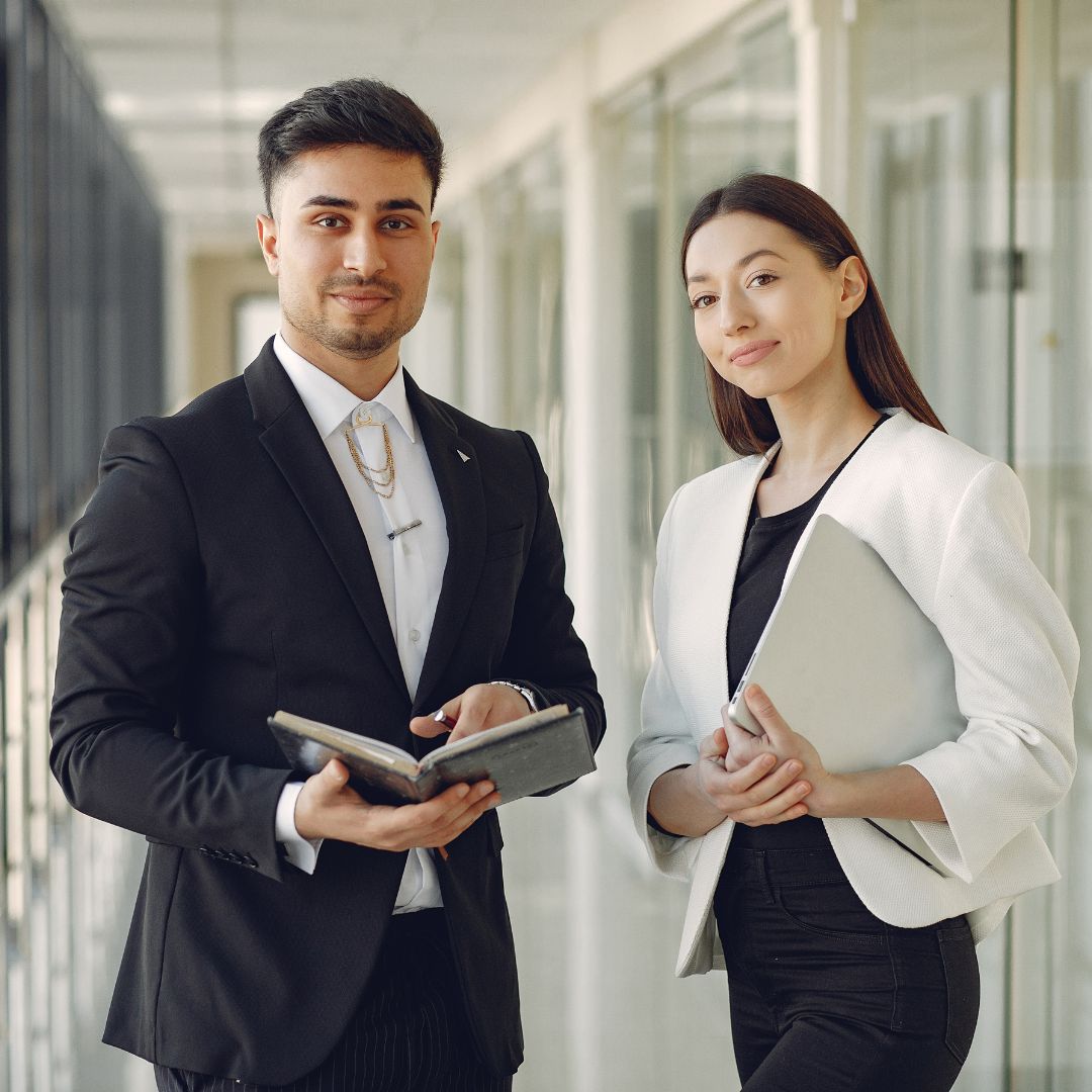 two employees smiling at camera