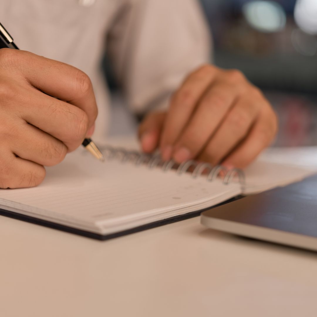 person writing down strengths