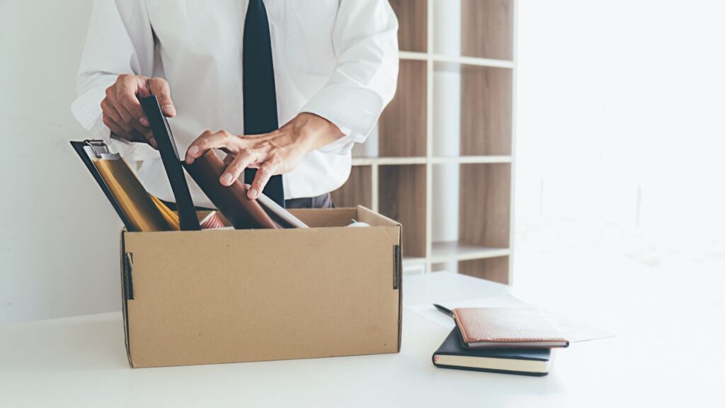 person packing up office supplies