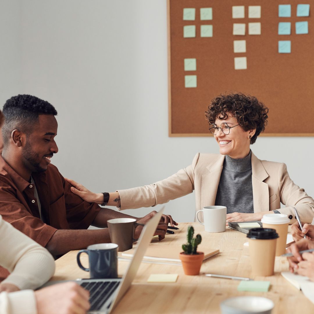 boss patting an employee on the arm