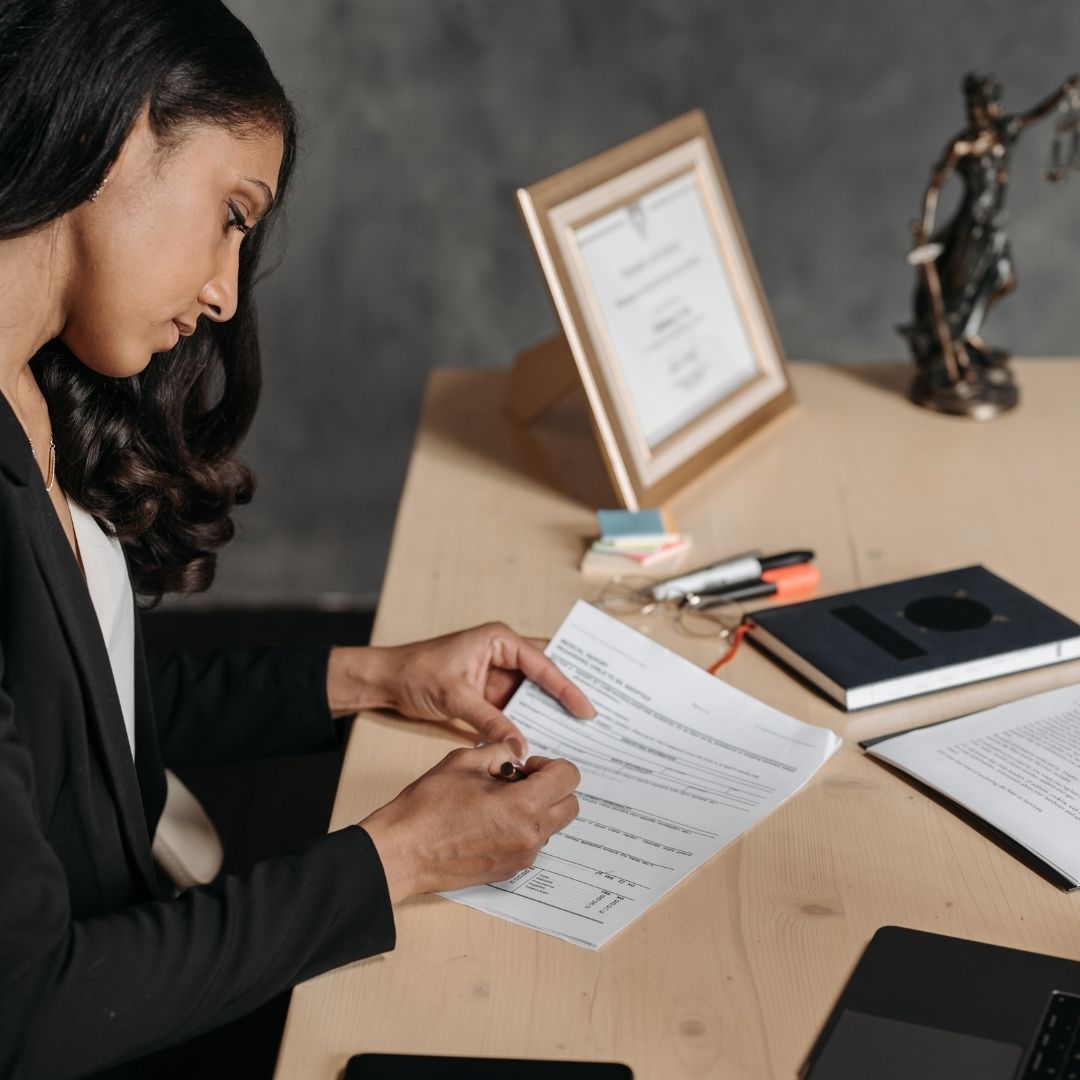 lawyer looks at document on desk